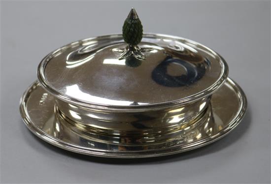 A George V silver butter dish, cover and stand, with glass liner and carved stained ivory finial, 13.6cm.